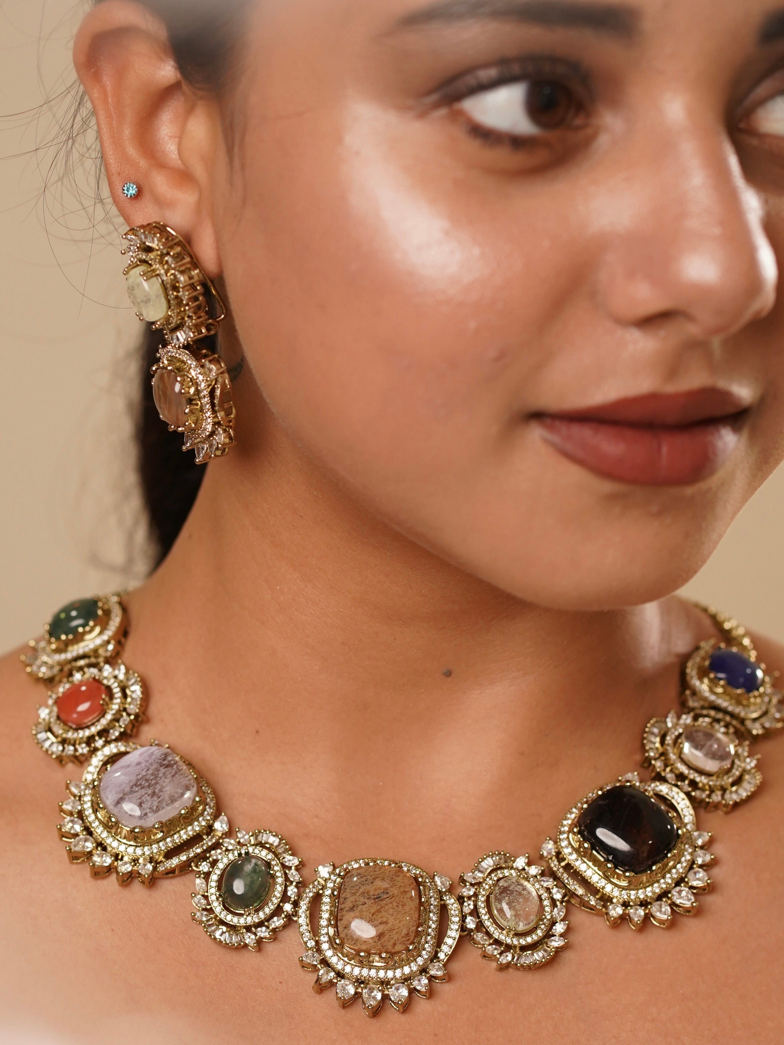 Angled view of navratna nazaakat necklace with uncut polki and kundan work in vibrant gemstone layout